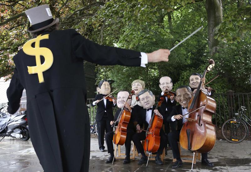 Activists dressed as musicians and wearing masks depicting leaders of the members of the G7 protest against wealth inequality outside the European Council building in Brussels June 4, 2014. The world's leading industrialized nations meet without Russia for the first time in 17 years on Wednesday, leaving President Vladimir Putin out of the talks in retaliation for his seizure of Crimea and Russia's part in destabilizing eastern Ukraine. The leaders depicted are (L-R) Japanese Prime Minister Shinzo Abe, British Prime Minister David Cameron, German Chancellor Angela Merkel, Canadian Prime Minister Stephen Harper, French President Francois Hollande, U.S. President Barack Obama and Italian Prime Minister Matteo Renzi. (Francois Lenoir/Reuters)